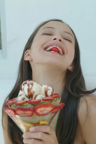 Mulher bonita desfrutando de sobremesa de frutas com gelado Fotos De Bancos De Imagens