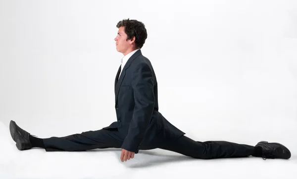 Good-looking businessman doing splits — Stock Photo, Image