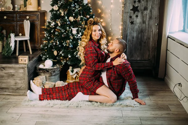 Beautiful couple in love relaxes on the floor in the living room together — Stock Photo, Image