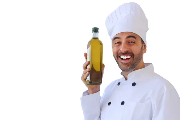 Laughing chef holding up a bottle of olive oil — Stock Photo, Image