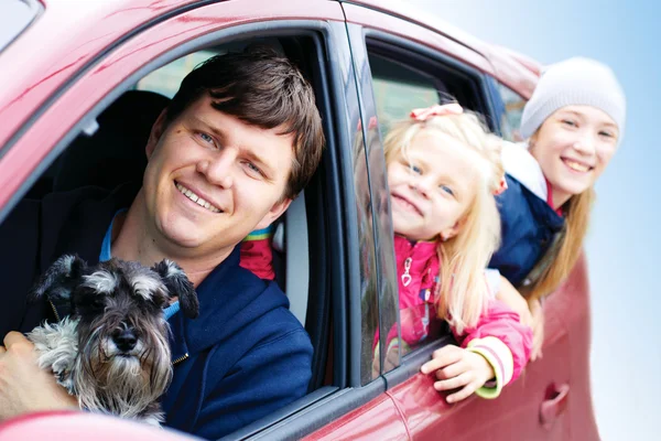 Family with a dog in the car
