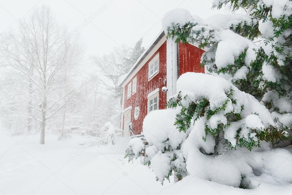 Red house in snowfall