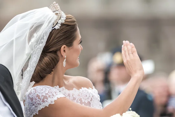 STOCKHOLM, Sweden - JUNE 8: Princess Madeleine waving to the crowd on the carriage to Riddarholmen after the wedding with Chris ONeill in Slottskyrkan. June 8, 2013, Stockholm, Sweden