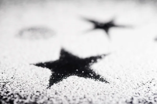 Black star made with powdered sugar — Stock Photo, Image