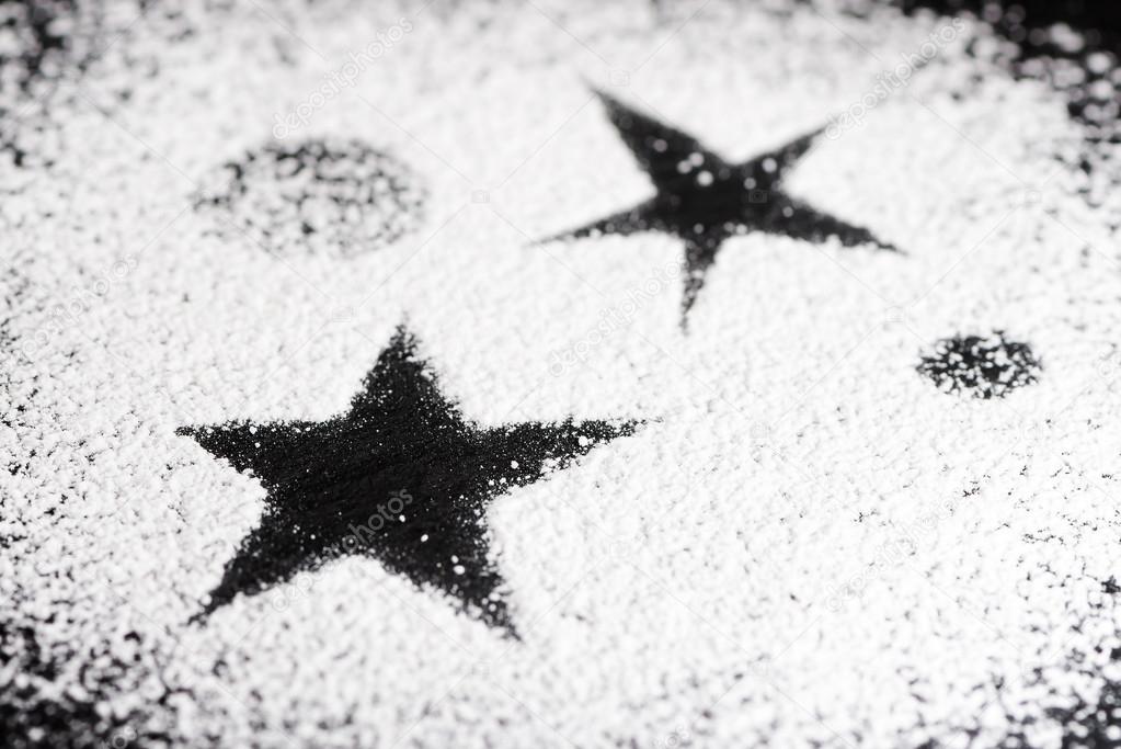 Black star and some planets made with powdered sugar