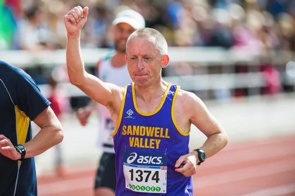 Man rising his hand on the final stretch at Stockholm Stadion — Stock Photo, Image