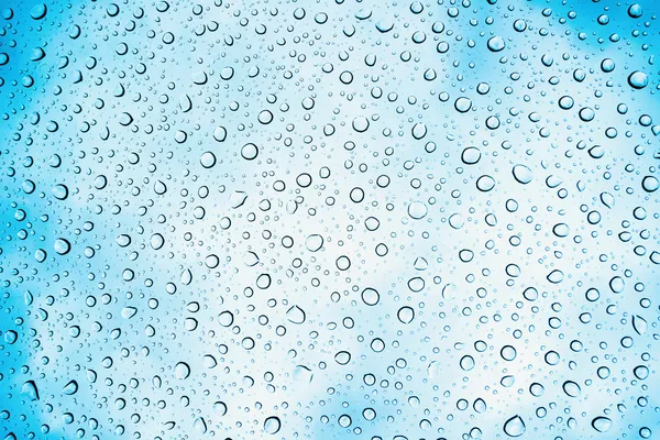 Water drops on glass with sky in background — Stock Photo, Image