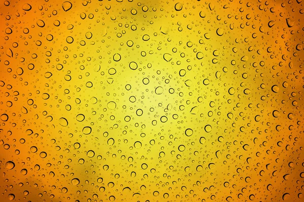 Drops on glass in orange and yellow — Stock Photo, Image