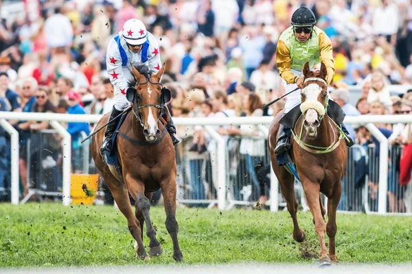 Two jockeys into last curve at the Nationaldags Galoppen — Stock Photo, Image