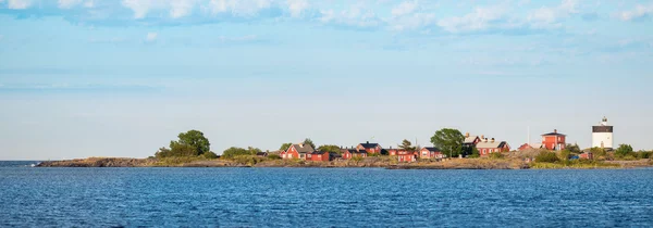 Panoramic view of a white lighthouse with red buildings — Stock Photo, Image