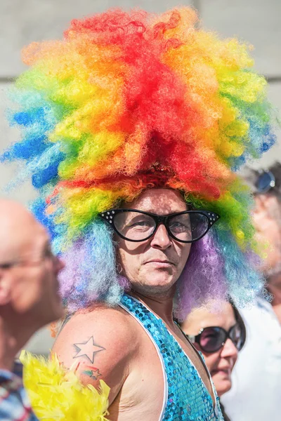 Man with a colorful wig and glasses — Stock Photo, Image