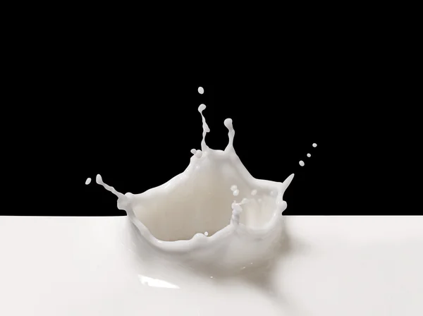 Salpicadura de leche sobre negro — Foto de Stock