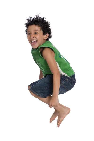 Ativo menino alegre pulando com alegria — Fotografia de Stock