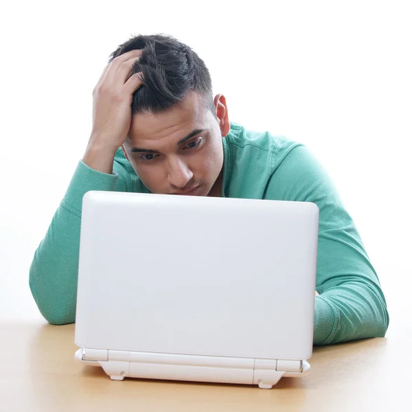 Young man staring at netbook — Stock Photo, Image