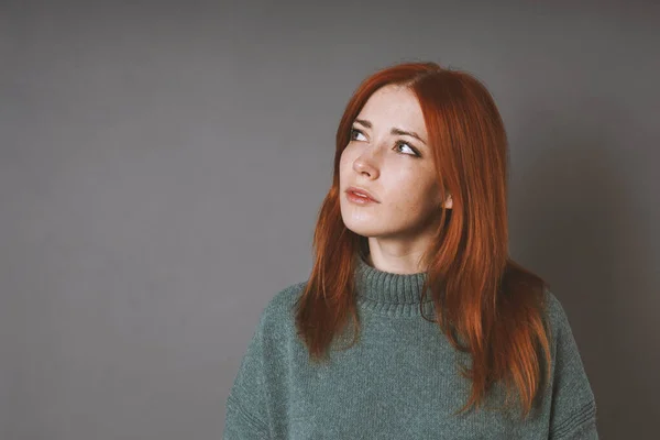 Thoughtful woman in turleneck sweater is looking up thinking or planning — Fotografia de Stock