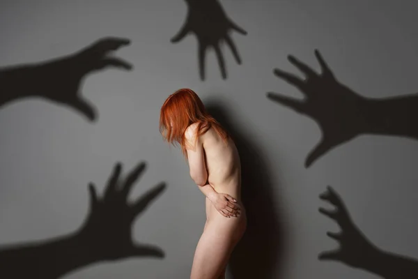 Sexual harassment or abuse concept with naked woman shadows of grabbing hands — Photo