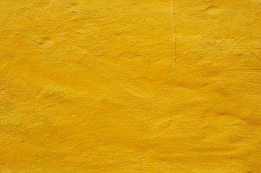 kaba alçı duvar parlak sarı arkaplan dokusuna boyanmış