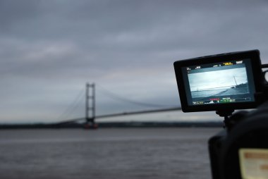 Humber Bridge being filmed on a professional video camera clipart
