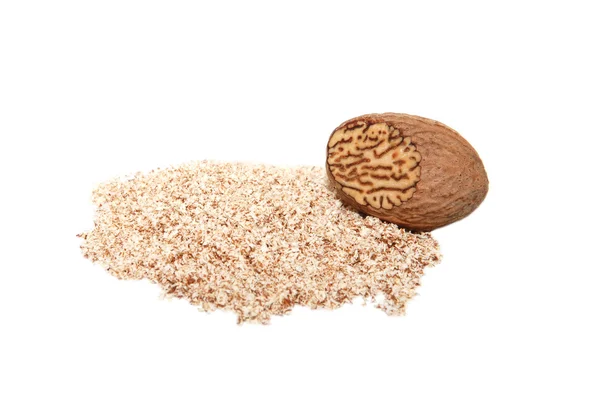 Grated nutmeg and whole nutmeg with grated face — Stock Photo, Image