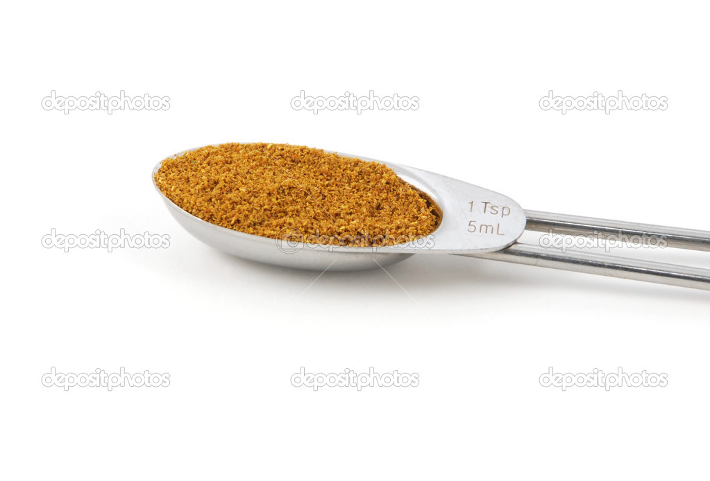 Curry powder measured in a metal teaspoon — Stock Photo © sarahdoow