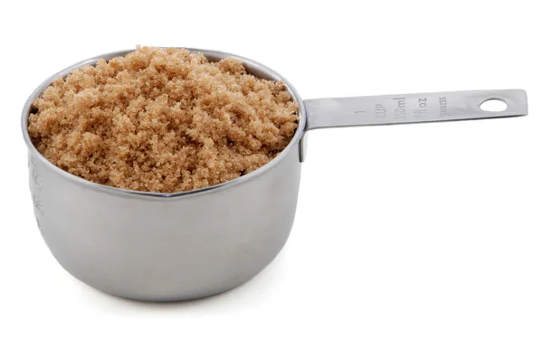 Light brown soft or muscovado sugar presented in a cup measure — Stock Photo, Image