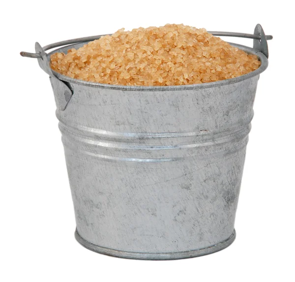 Demerara sugar in a miniature metal bucket — Stock Photo, Image