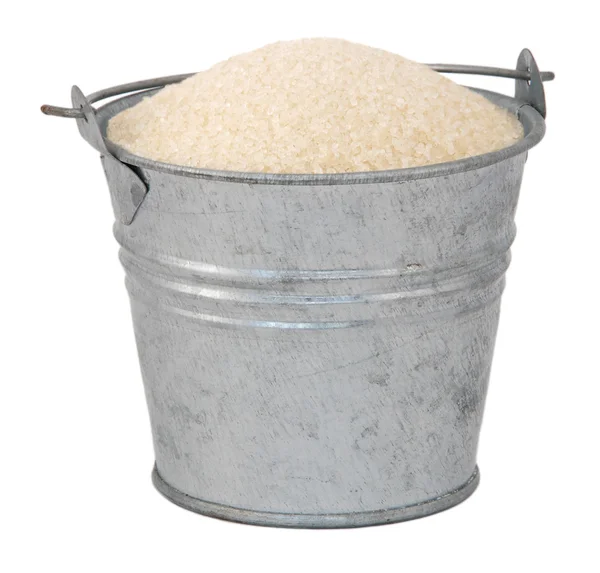 Golden granulated sugar in a miniature metal bucket — Stock Photo, Image