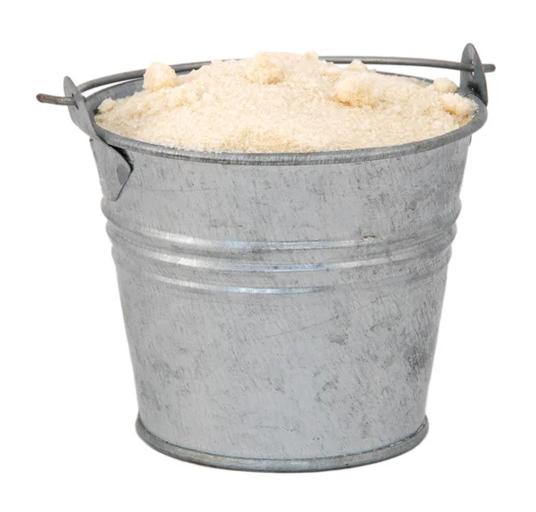 Golden caster sugar in a miniature metal bucket — Stock Photo, Image