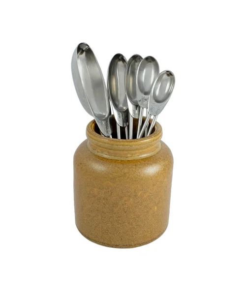 Metal measuring spoons in a ceramic pot — Stock Photo, Image