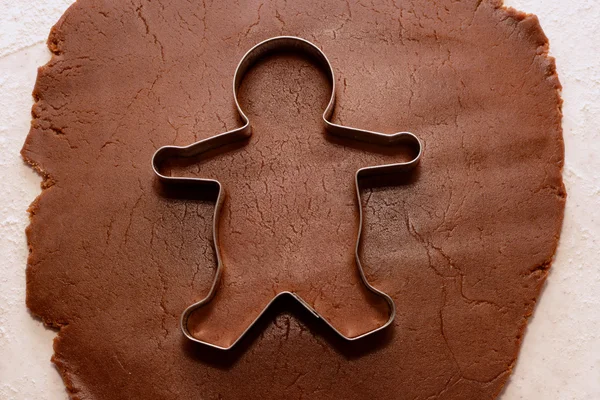 Cutting out a gingerbread man — Stock Photo, Image