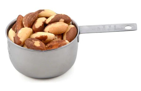 Whole brazil nuts in a metal cup measure — Stock Photo, Image