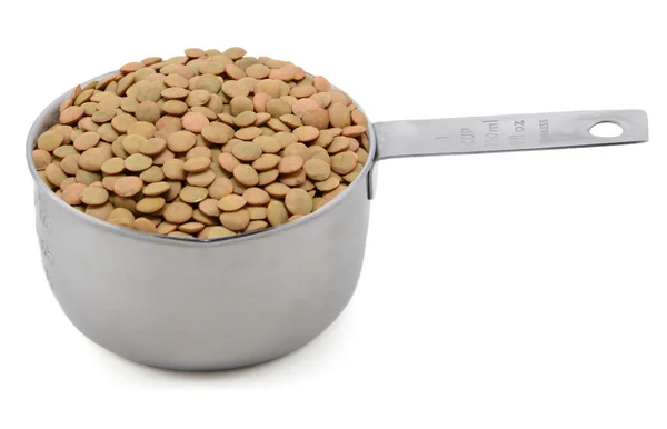 Green lentils in an American cup measure — Stock Photo, Image