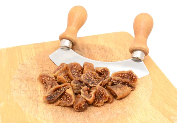 Chopped soft dried figs with a rocking knife — Stock Photo, Image