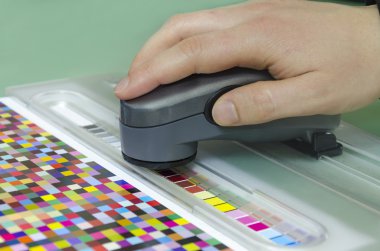 Spectrophotometer verify color patches on Test Arch, Press shop prepress department clipart