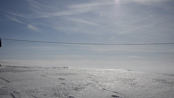 Parents silhouette giving their children family a sledge ride in snow edge — Stock Video