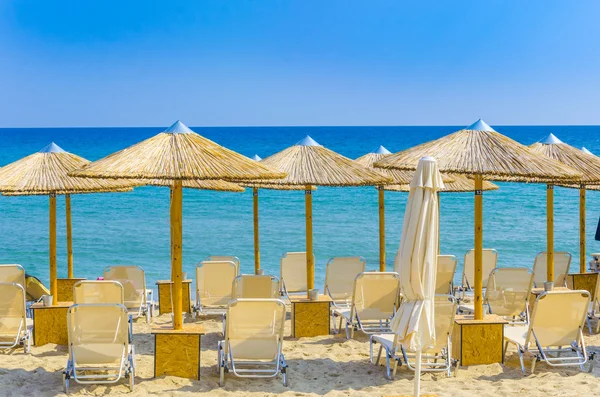 Sun loungers with an umbrella on the beach — Stock Photo, Image