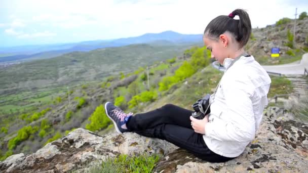 Girl on mountain peak with binocular — Stock Video