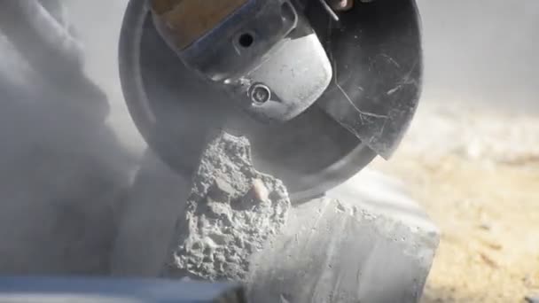 Angle grinder cutting concrete block for road construction — Stock Video