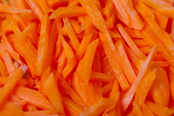 Морковные палочки, оранжевый фон — стоковое фото