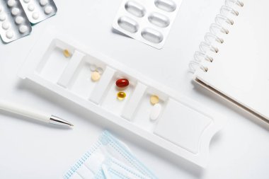 Eczane ilaç organizatörü masanın üstünde.