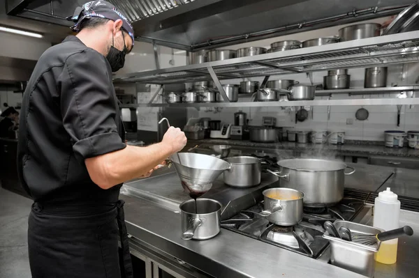 Chef cooking in modern industrial kitchen. — Stock Photo, Image