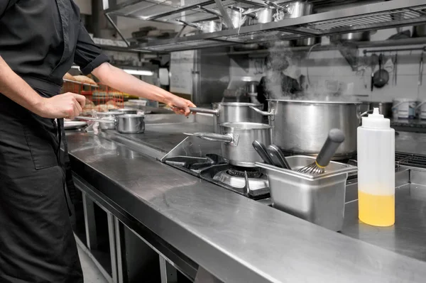 Unrecognizable Chef cooking in modern industrial kitchen. — Stock Photo, Image