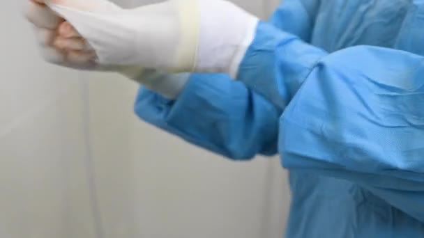 Chirurg verwijdert chirurgische handschoenen in operatiekamer — Stockvideo