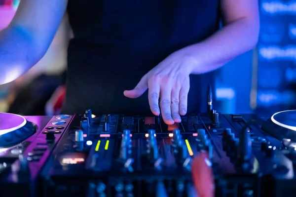 Close up Front view of of DJ hands controlling a music table in a night club. — Stock Photo, Image