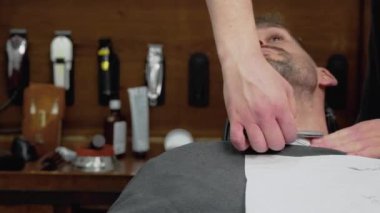 Keskin bir ustura ile tıraş sakallı erkek berber