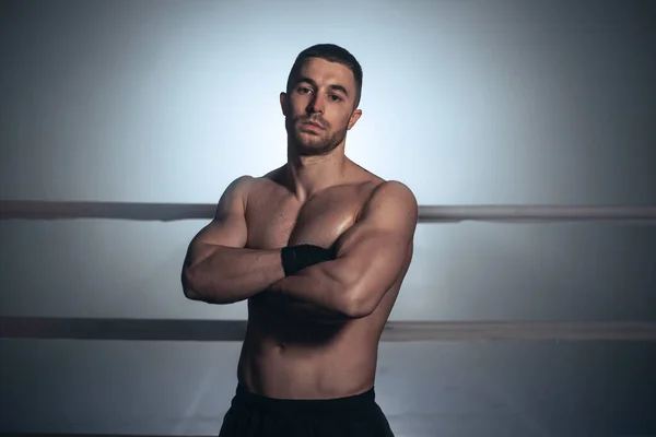 Mixed martial arts fighter posing in a ring.