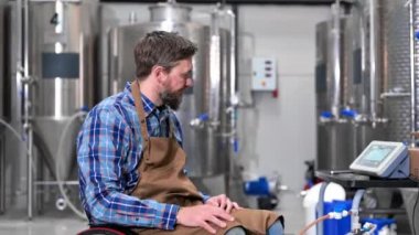 Man in wheel chair working in Brewery factory.