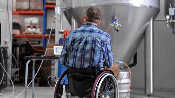 Man in wheel chair working in Brewery factory. — стоковое видео