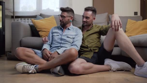 Happy Gay Couple Sitting Floor Playing Dog Home High Quality — Stock Video