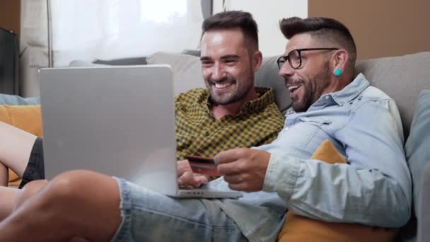 Happy Young Gay Couple Using Laptop Computer While Sitting Couch — Αρχείο Βίντεο